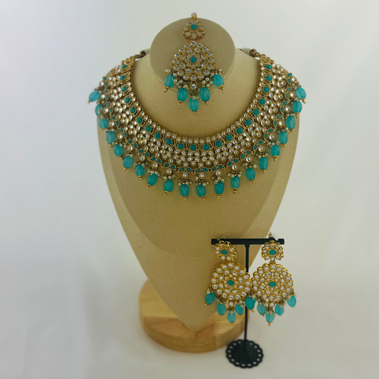 Necklace set with turquoise stones and beads. Set includes necklace, tikka & earrings. Prefect for Indian weddings, parties and special occasions. Latest 2023 fashion. High end Indian fashion jewellery with top quality stones and beads.