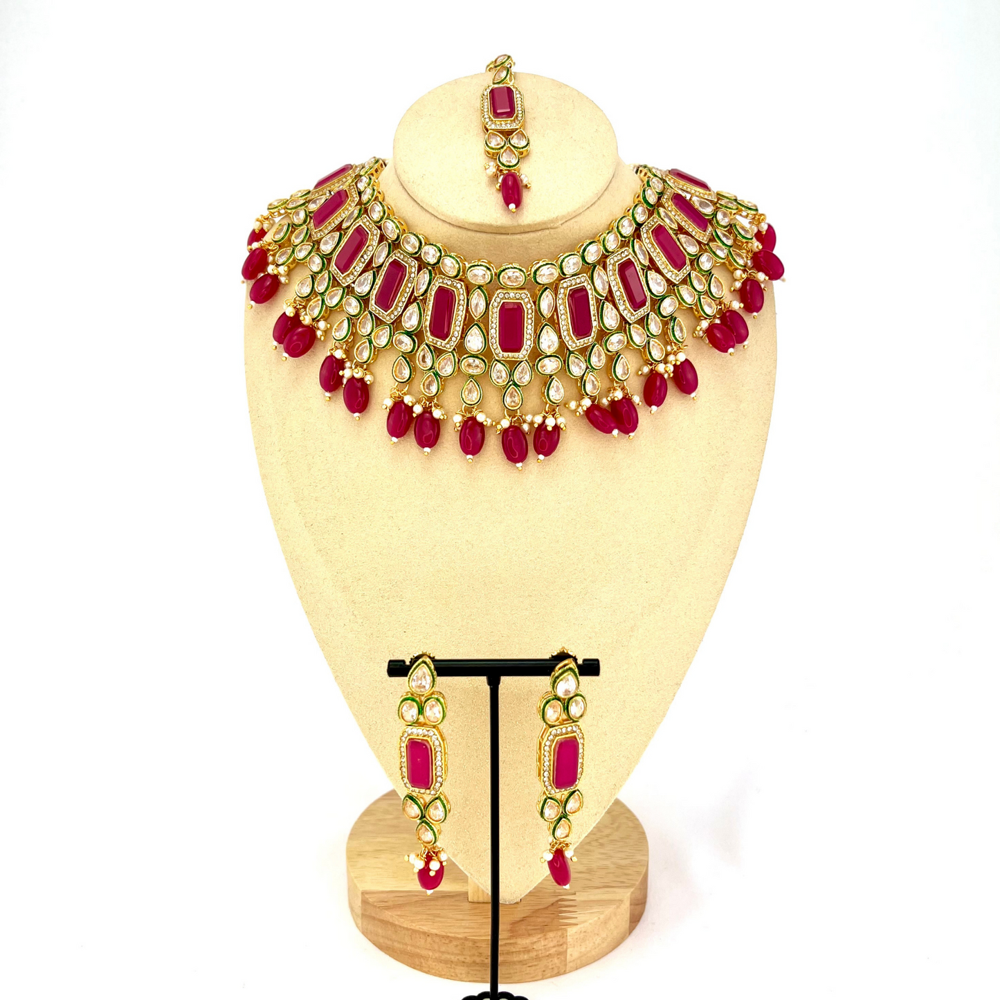 Necklace set with hot pink beads and clear and hot pink stones. Set includes necklace, tikka and earrings. Prefect for Indian weddings, parties and special occasions. Latest 2022 fashion. High end Indian fashion jewellery with top quality stones and beads.
