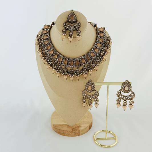 Necklace set with peach stones and beads. Set includes necklace, tikka & earrings. Prefect for Indian weddings, parties and special occasions. Latest 2023 fashion. High end Indian fashion jewellery with top quality stones and beads.