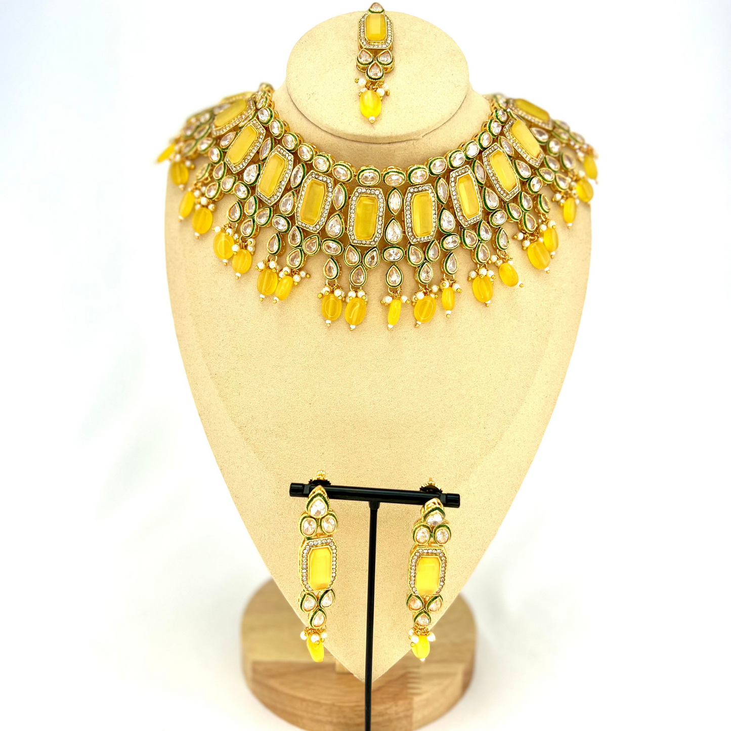 Necklace set with yellow beads and clear and yellow stones. Set includes necklace, tikka and earrings. Prefect for Indian weddings, parties and special occasions. Latest 2022 fashion. High end Indian fashion jewellery with top quality stones and beads.