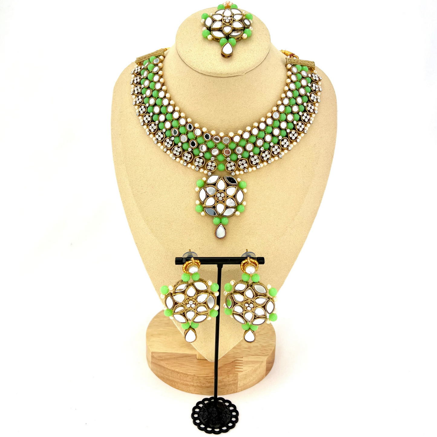 Mirror necklace set with green beads, clear stones and pearls. Set includes, necklace, tikka and earrings. Prefect for Indian weddings, parties and special occasions. Latest 2022 fashion. High end Indian fashion jewellery with top quality stones and beads.