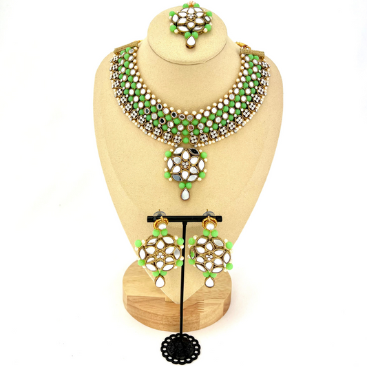 Mirror necklace set with green beads, clear stones and pearls. Set includes, necklace, tikka and earrings. Prefect for Indian weddings, parties and special occasions. Latest 2022 fashion. High end Indian fashion jewellery with top quality stones and beads.