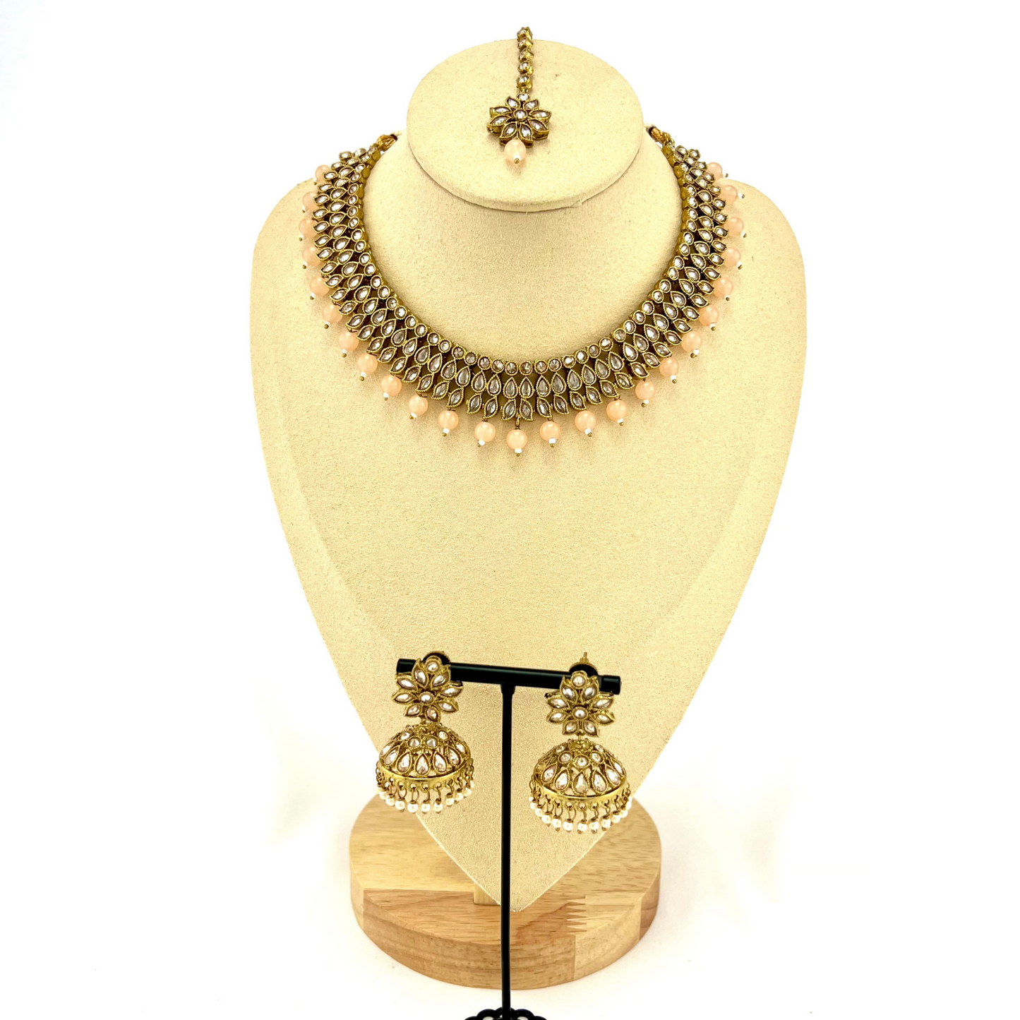 Necklace set with peach beads and gold stones. Set includes necklace, tikka & earrings. Prefect for Indian weddings, parties and special occasions. Latest 2022 fashion. High end Indian fashion jewellery with top quality stones and beads.