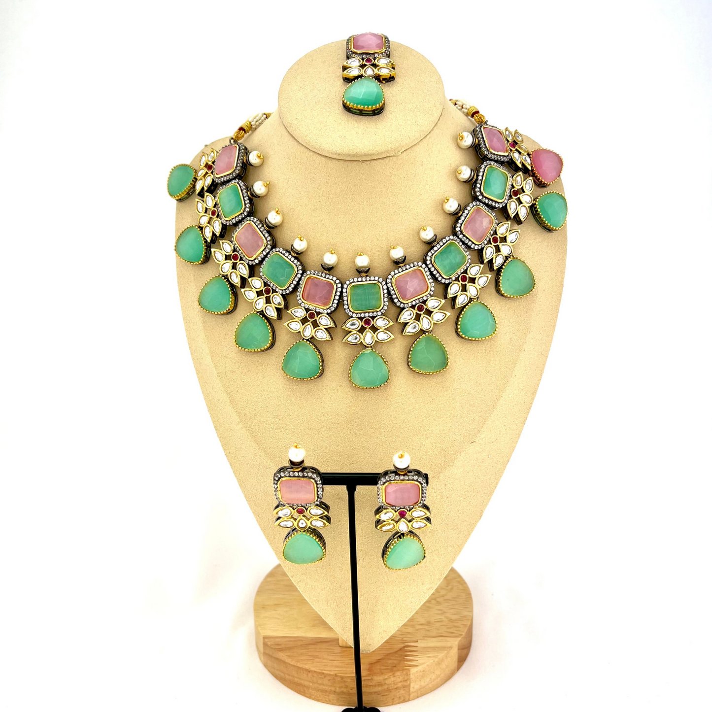 Necklace set with green, pink and silver stone work finished with small white pearls. Set includes necklace, tikka and earrings. Prefect for Indian parties, weddings and special occasions. Latest 2022 fashion