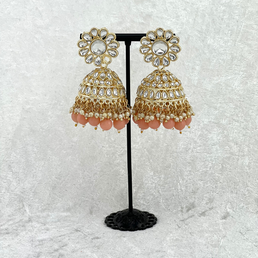 Jhumka earrings in peach with stones, pearls and beads. Indian wedding jewellery prefect for weddings, parties and special occasions. latest high quality 2022 fashion
