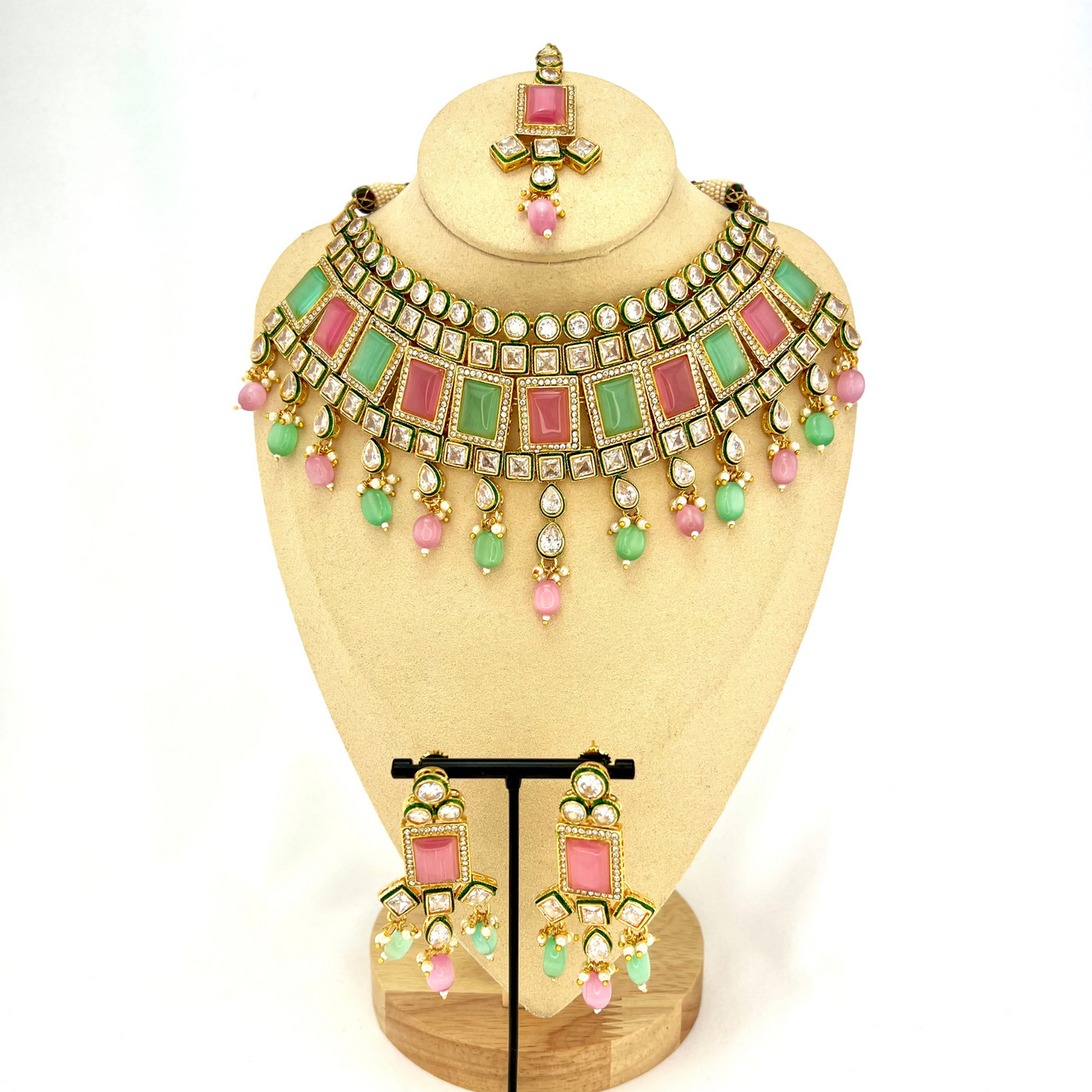 Necklace set with green, pink and clear stones and green and pink beads. Set includes necklace, tikka and earrings. Prefect for Indian weddings, parties and special occasions. Latest 2022 fashion. High end Indian fashion jewellery with top quality stones and beads.