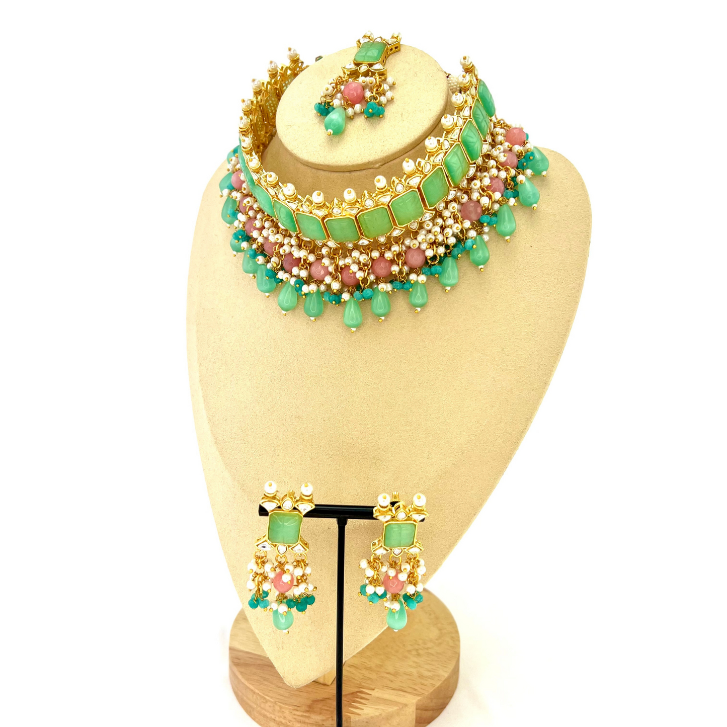 Choker set with with green, clear stones and pink and blue beads. Set includes choker, tikka and earrings. Prefect for Indian weddings, parties and special occasions. Latest 2022 fashion. High end Indian fashion jewellery with top quality stones and beads.