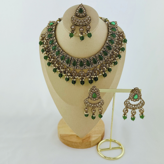 Necklace set with green beads and stone. Set includes necklace, tikka & earrings. Prefect for Indian weddings, parties and special occasions. Latest 2023 fashion. High end Indian fashion jewellery with top quality stones and beads.
