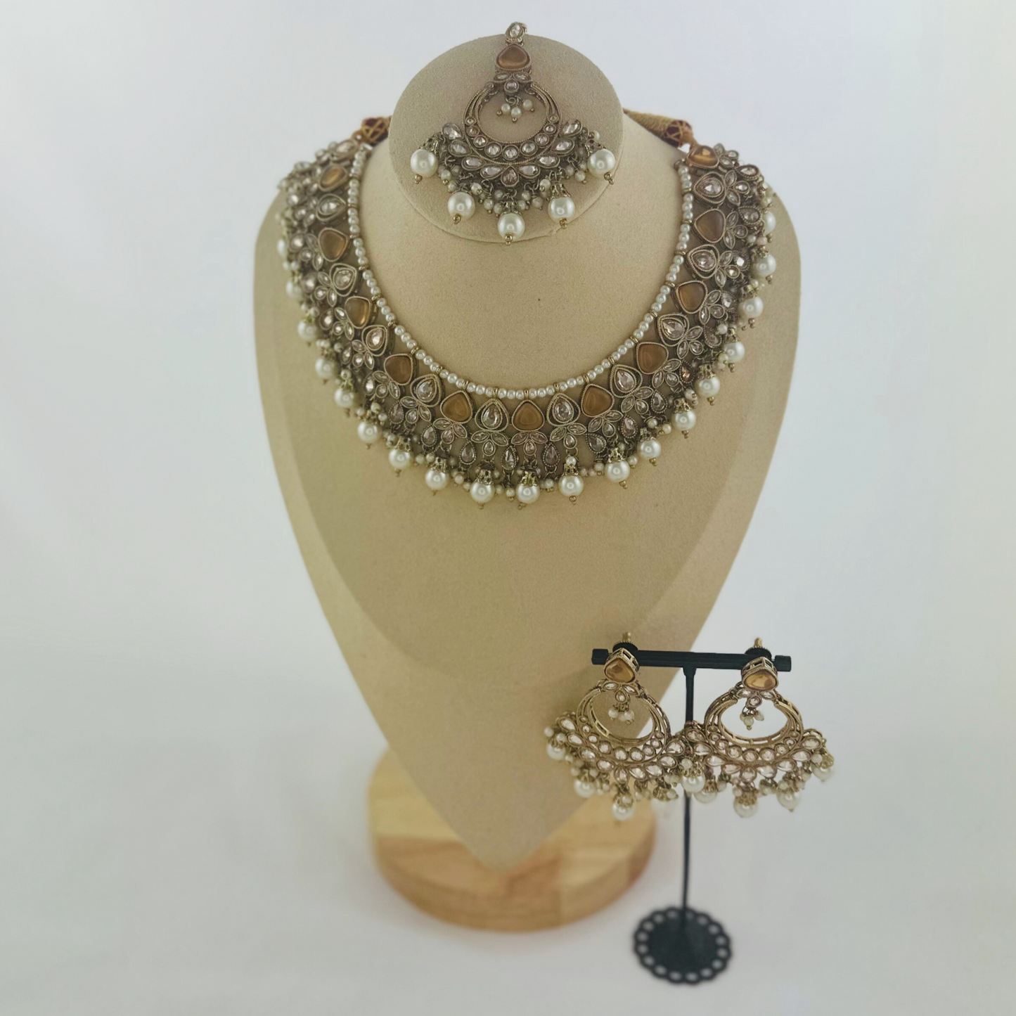 Necklace set with bronze stones and white pearl beads. Set includes necklace, tikka & earrings. Prefect for Indian weddings, parties and special occasions. Latest 2023 fashion. High end Indian fashion jewellery with top quality stones and beads.