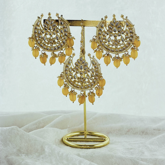 Tikka & earring set in yellow. High quality beads, pearls and stone work. Latest 2023 fashion for weddings, parties and special occasions