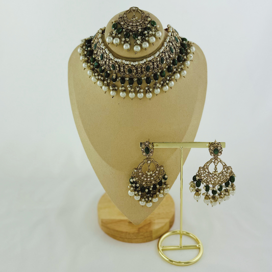 Necklace set with green stones and white pearl beads. Set includes necklace, tikka & earrings. Prefect for Indian weddings, parties and special occasions. Latest 2023 fashion. High end Indian fashion jewellery with top quality stones and beads.