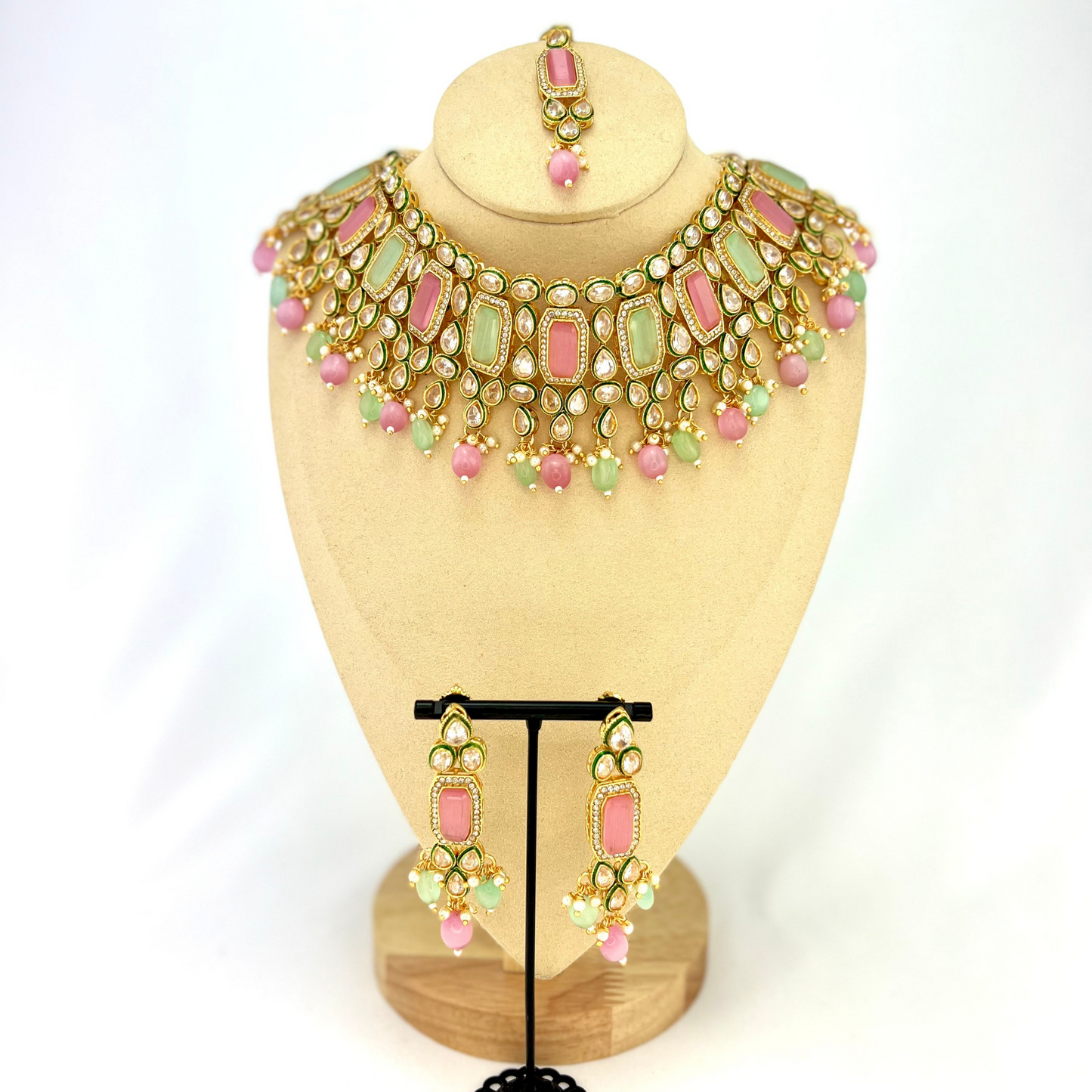 Necklace set with green, pink and clear stones and green and pink beads. Set includes necklace, tikka and earrings. Prefect for Indian weddings, parties and special occasions. Latest 2022 fashion. High end Indian fashion jewellery with top quality stones and beads.