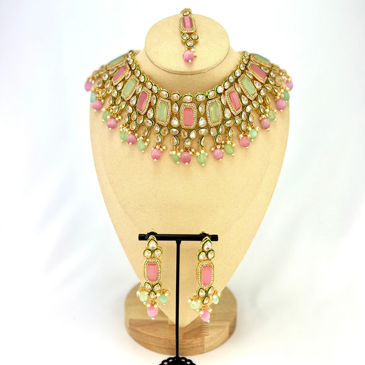 Necklace set with green, pink and clear stones and green and pink beads. Set includes necklace, tikka and earrings. Prefect for Indian weddings, parties and special occasions. Latest 2022 fashion. High end Indian fashion jewellery with top quality stones and beads.