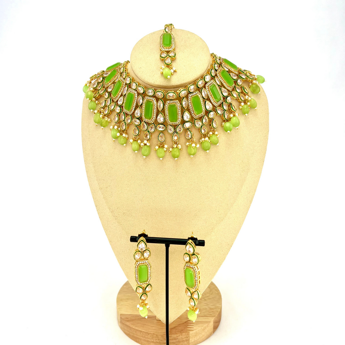 Necklace set with mint green beads and clear and mint green stones. Set includes necklace, tikka and earrings. Prefect for Indian weddings, parties and special occasions. Latest 2022 fashion. High end Indian fashion jewellery with top quality stones and beads.