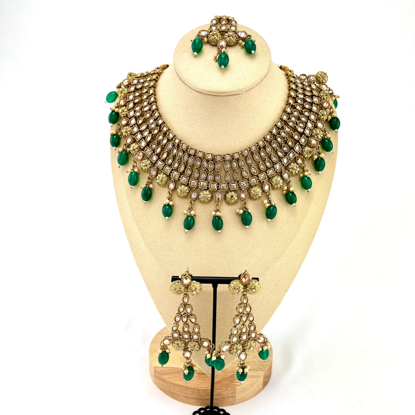 Necklace set with green beads and gold stone work. Set includes necklace, tikka and earrings. Prefect for Indian weddings, parties and special occasions. Latest 2022 fashion. High end Indian fashion jewellery with top quality stones and beads.