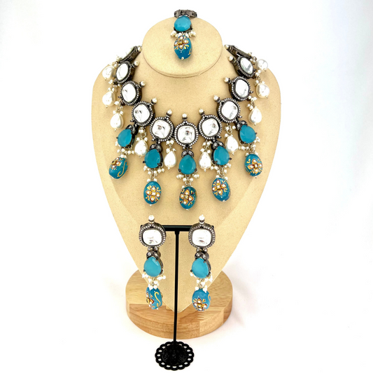 Kundan necklace set with with clear and blue stones. Set includes necklace, tikka and earrings. Prefect for Indian weddings, parties and special occasions. Latest 2022 fashion. High end Indian fashion jewellery with top quality stones and beads.