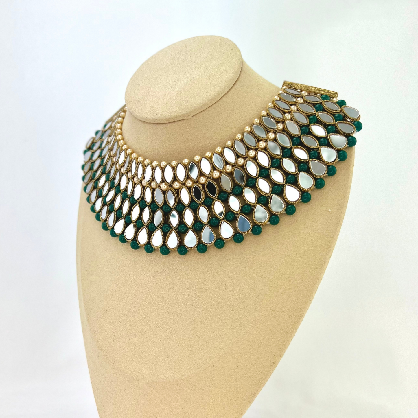 Mirror necklace set with forest green beads, clear stones and pearls. Set includes, necklace, tikka and earrings. Prefect for Indian weddings, parties and special occasions. Latest 2022 fashion. High end Indian fashion jewellery with top quality stones and beads.