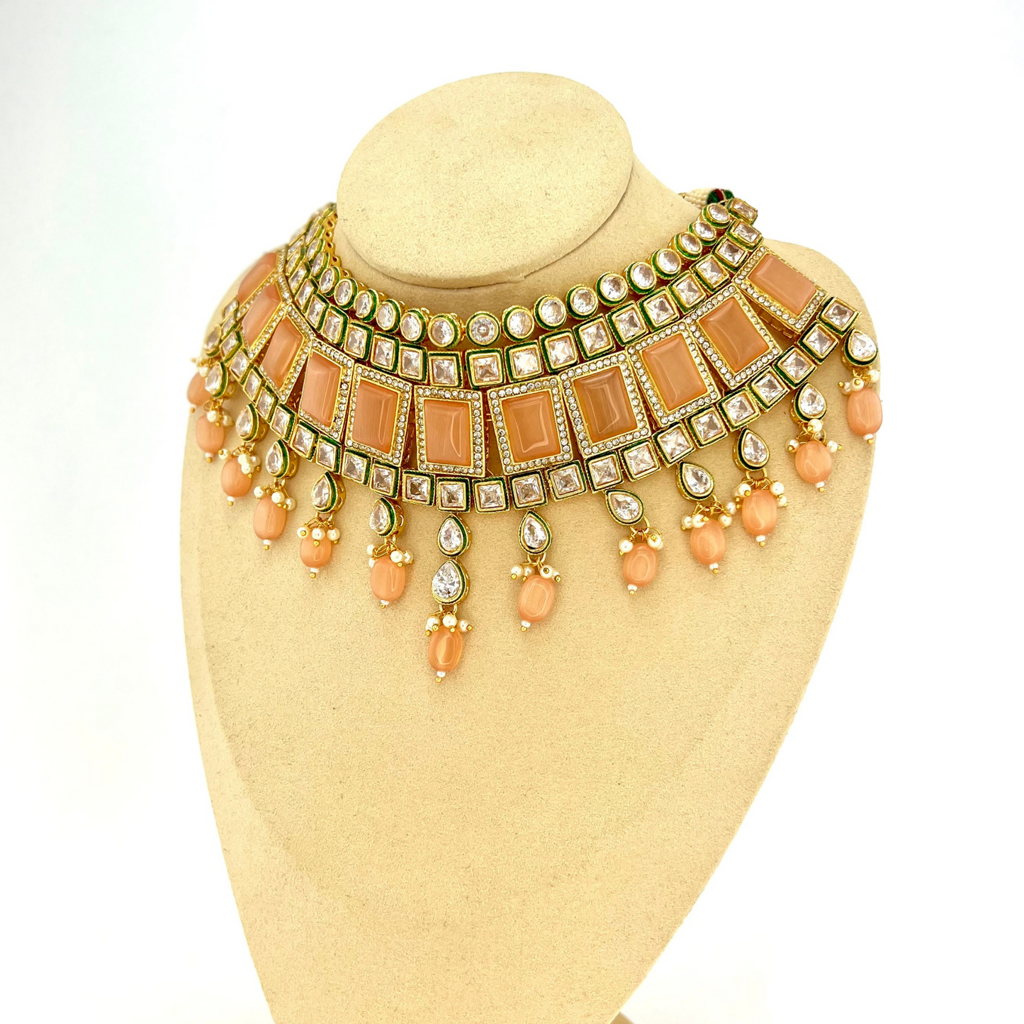 Necklace set with peach and clear stones and peach beads. Set includes necklace, tikka and earrings. Prefect for Indian weddings, parties and special occasions. Latest 2022 fashion. High end Indian fashion jewellery with top quality stones and beads.