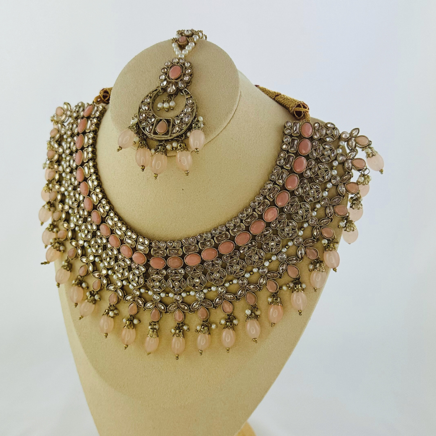 Necklace set with pink bead and stones. Set includes necklace, tikka & earrings. Prefect for Indian weddings, parties and special occasions. Latest 2023 fashion. High end Indian fashion jewellery with top quality stones and beads.