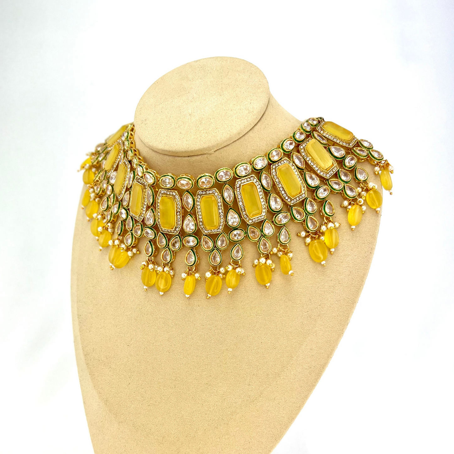 Necklace set with yellow beads and clear and yellow stones. Set includes necklace, tikka and earrings. Prefect for Indian weddings, parties and special occasions. Latest 2022 fashion. High end Indian fashion jewellery with top quality stones and beads.