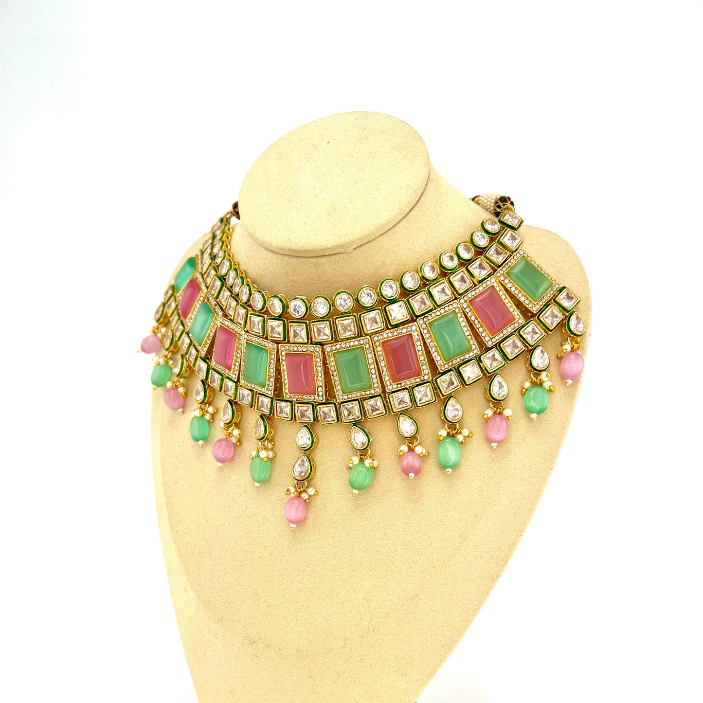 Necklace set with green, pink and clear stones and green and pink beads. Set includes necklace, tikka and earrings. Prefect for Indian weddings, parties and special occasions. Latest 2022 fashion. High end Indian fashion jewellery with top quality stones and beads.