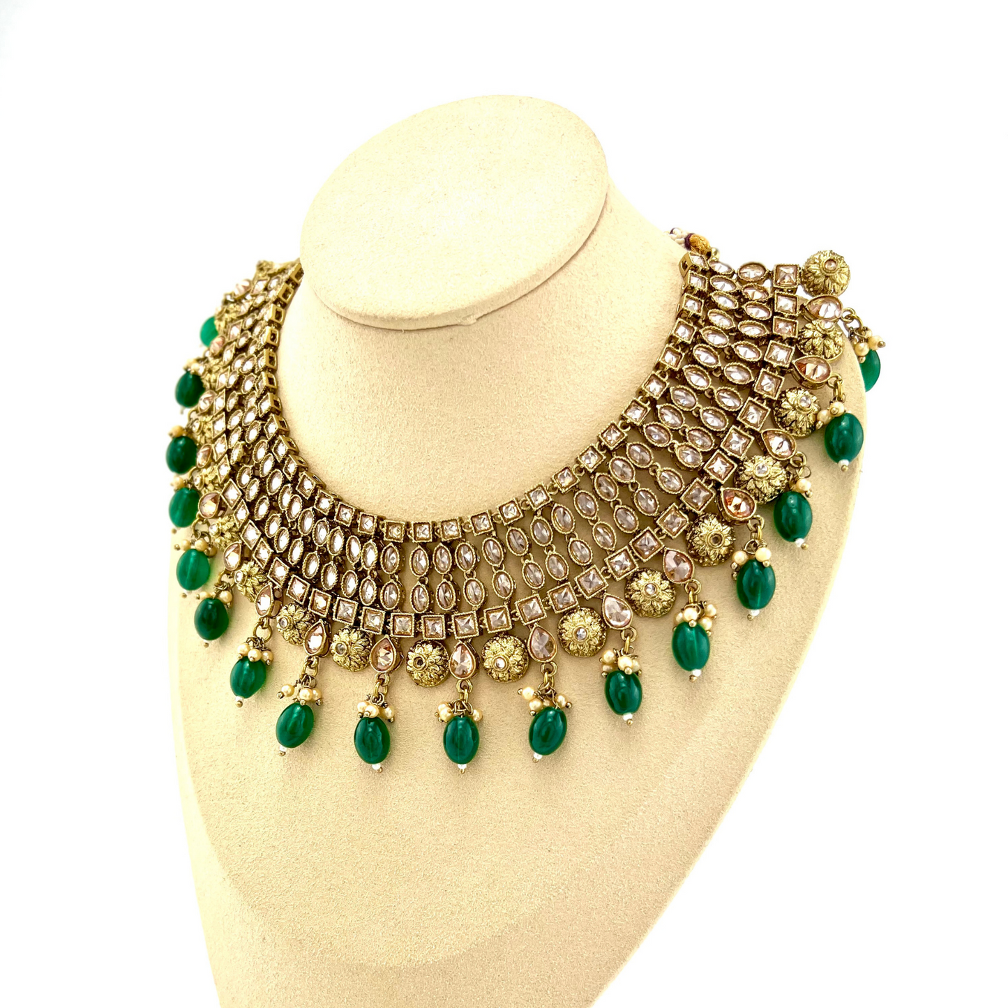 Necklace set with green beads and gold stone work. Set includes necklace, tikka and earrings. Prefect for Indian weddings, parties and special occasions. Latest 2022 fashion. High end Indian fashion jewellery with top quality stones and beads.