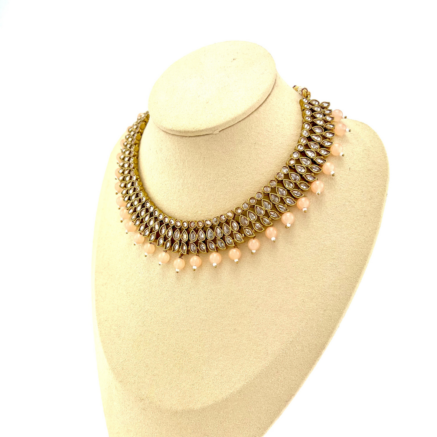 Necklace set with peach beads and gold stones. Set includes necklace, tikka & earrings. Prefect for Indian weddings, parties and special occasions. Latest 2022 fashion. High end Indian fashion jewellery with top quality stones and beads.