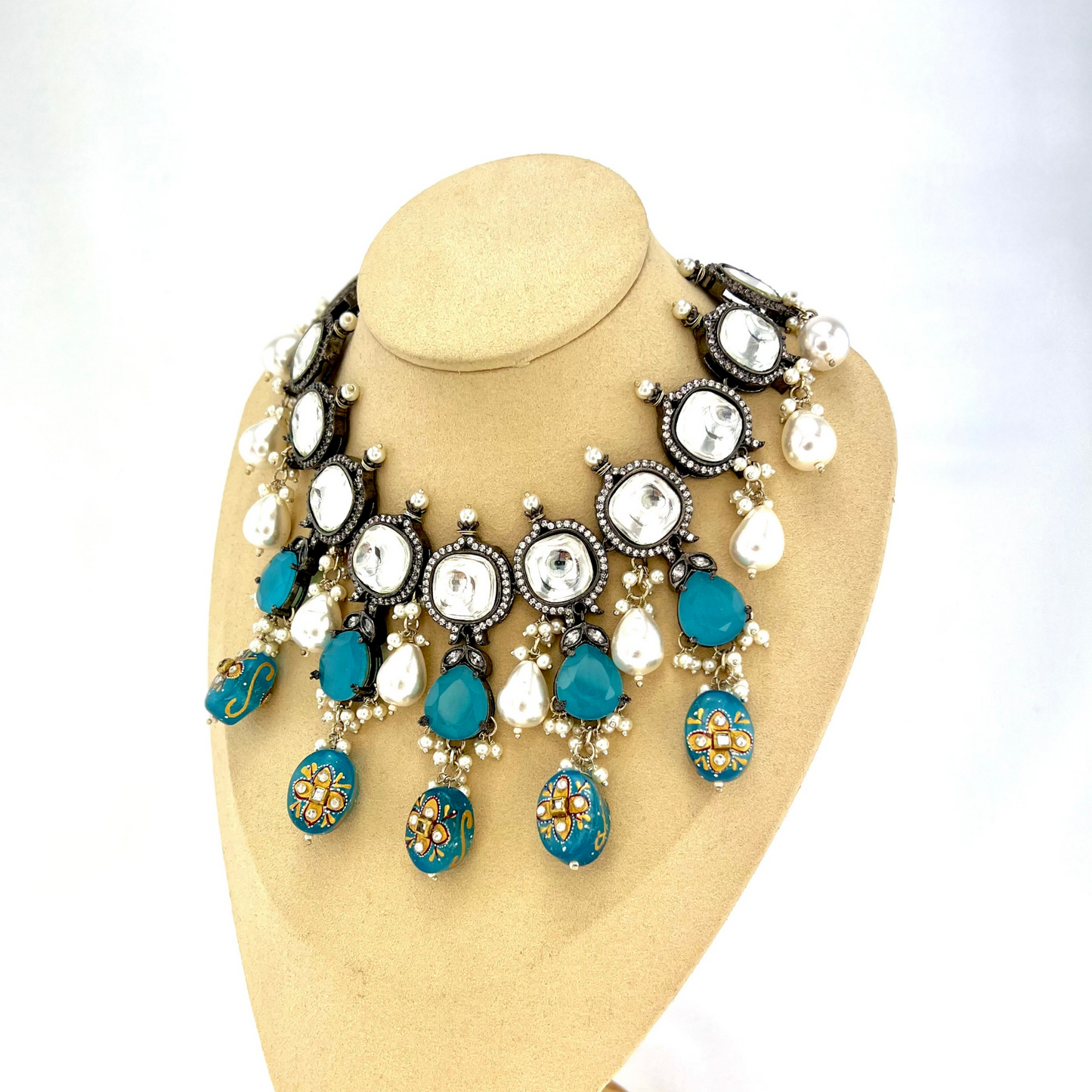Kundan necklace set with with clear and blue stones. Set includes necklace, tikka and earrings. Prefect for Indian weddings, parties and special occasions. Latest 2022 fashion. High end Indian fashion jewellery with top quality stones and beads.