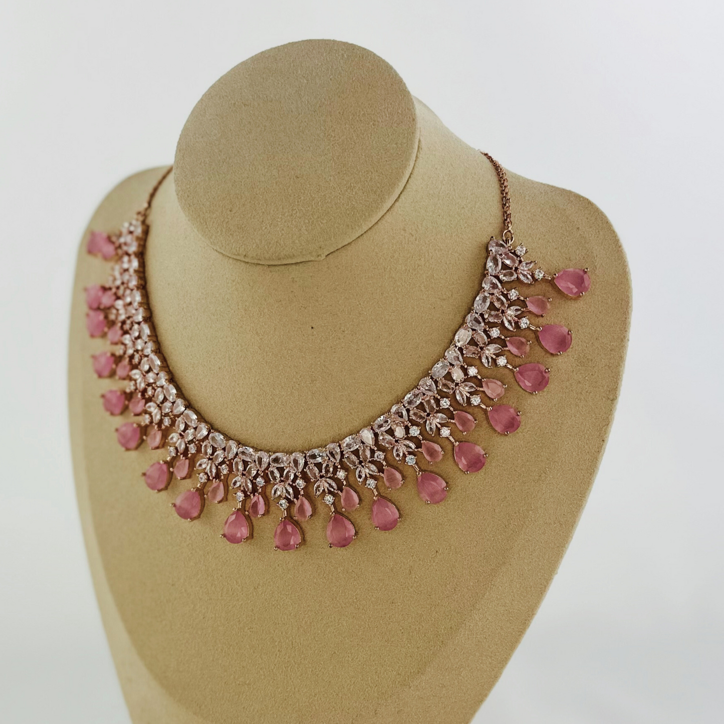 Rosegold necklace set with clear and pink stones. Set includes necklace & earrings. Prefect for Indian weddings, parties and special occasions. Latest 2023 fashion. High end Indian fashion jewellery with top quality stones and beads.