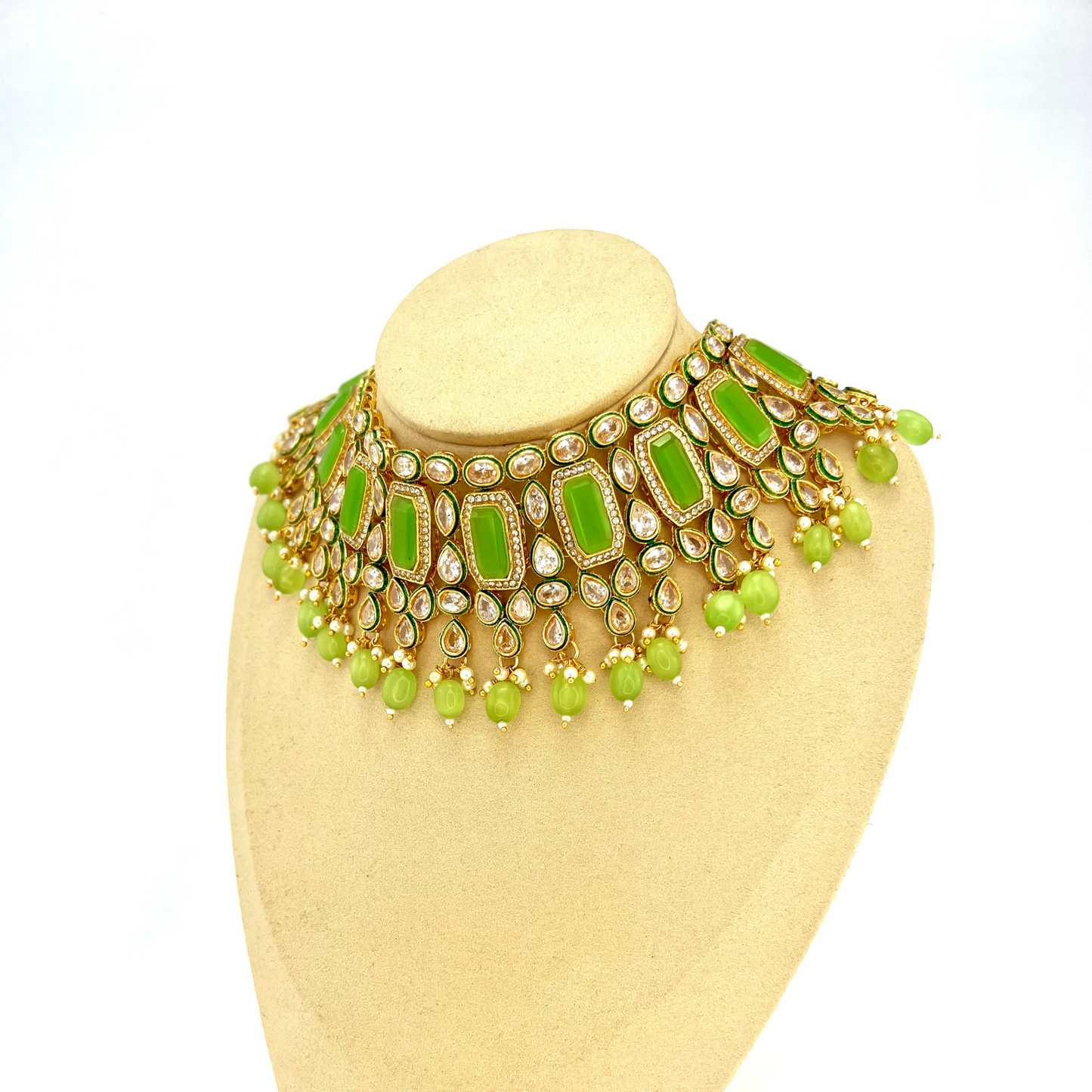 Necklace set with mint green beads and clear and mint green stones. Set includes necklace, tikka and earrings. Prefect for Indian weddings, parties and special occasions. Latest 2022 fashion. High end Indian fashion jewellery with top quality stones and beads.