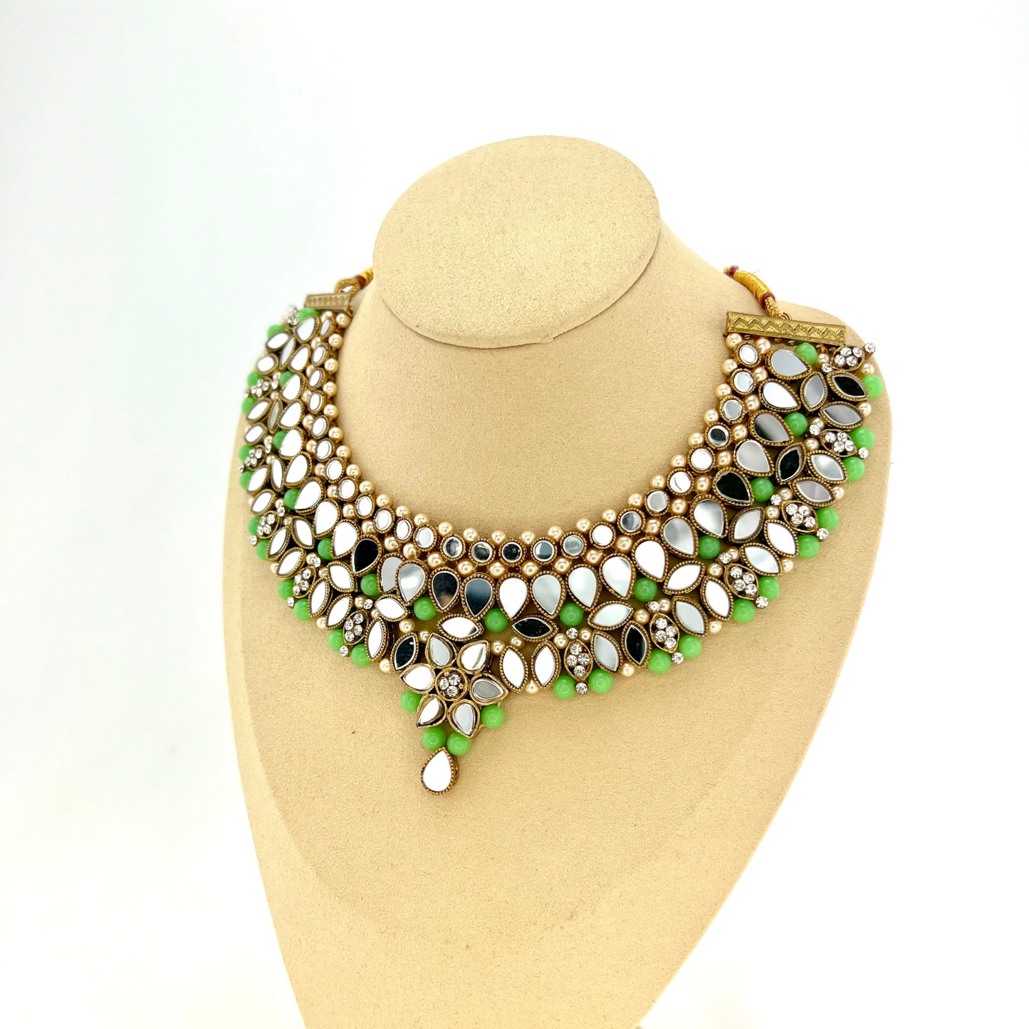 Mirror necklace set with green beads, clear stones and pearls. Set includes, necklace, tikka and earrings. Prefect for Indian weddings, parties and special occasions. Latest 2022 fashion. High end Indian fashion jewellery with top quality stones and beads.