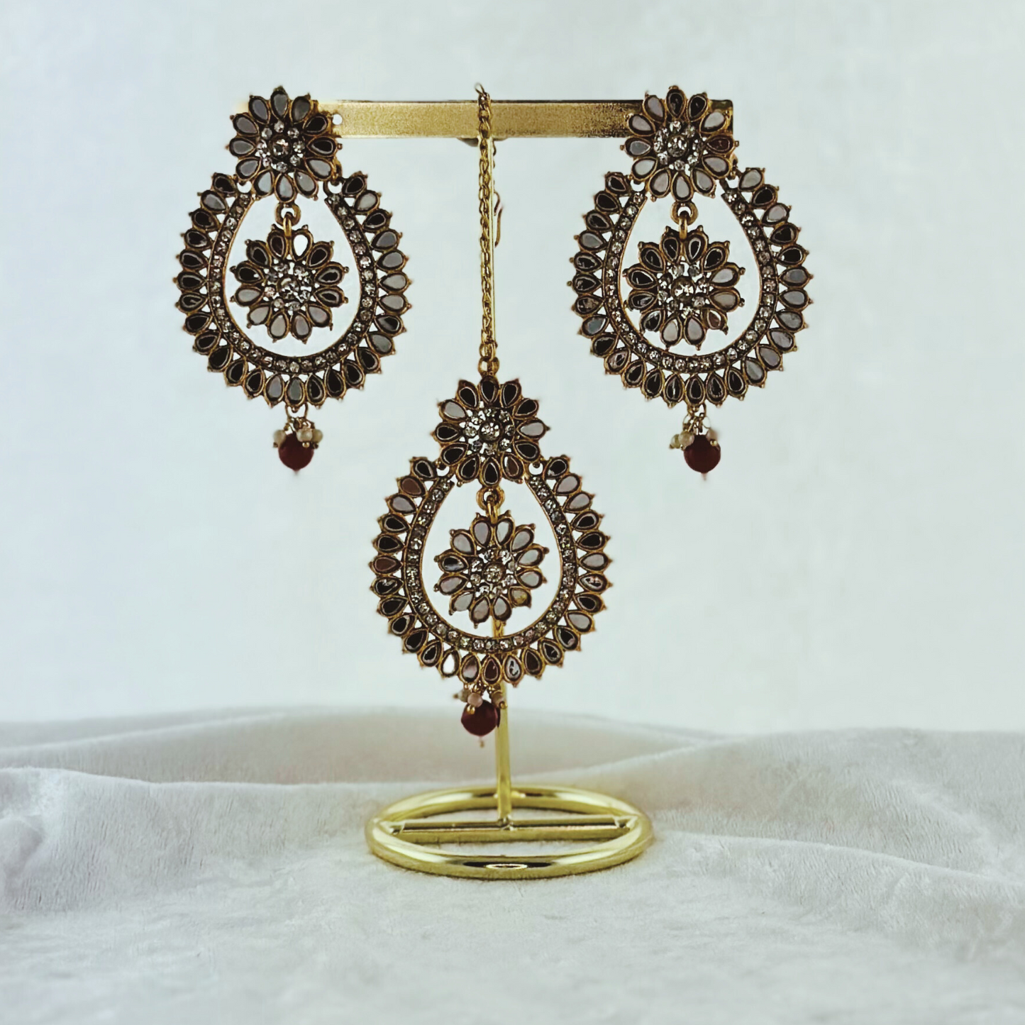 Tikka & earring set in maroon. High quality beads, pearls and stone work. Latest 2023 fashion for weddings, parties and special occasions