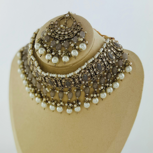 Necklace set with grey stones and white pearl beads. Set includes necklace, tikka & earrings. Prefect for Indian weddings, parties and special occasions. Latest 2023 fashion. High end Indian fashion jewellery with top quality stones and beads.