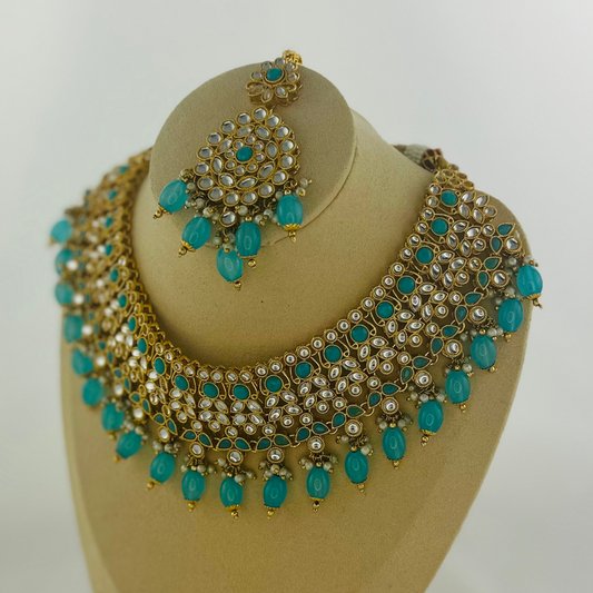 Necklace set with turquoise stones and beads. Set includes necklace, tikka & earrings. Prefect for Indian weddings, parties and special occasions. Latest 2023 fashion. High end Indian fashion jewellery with top quality stones and beads.