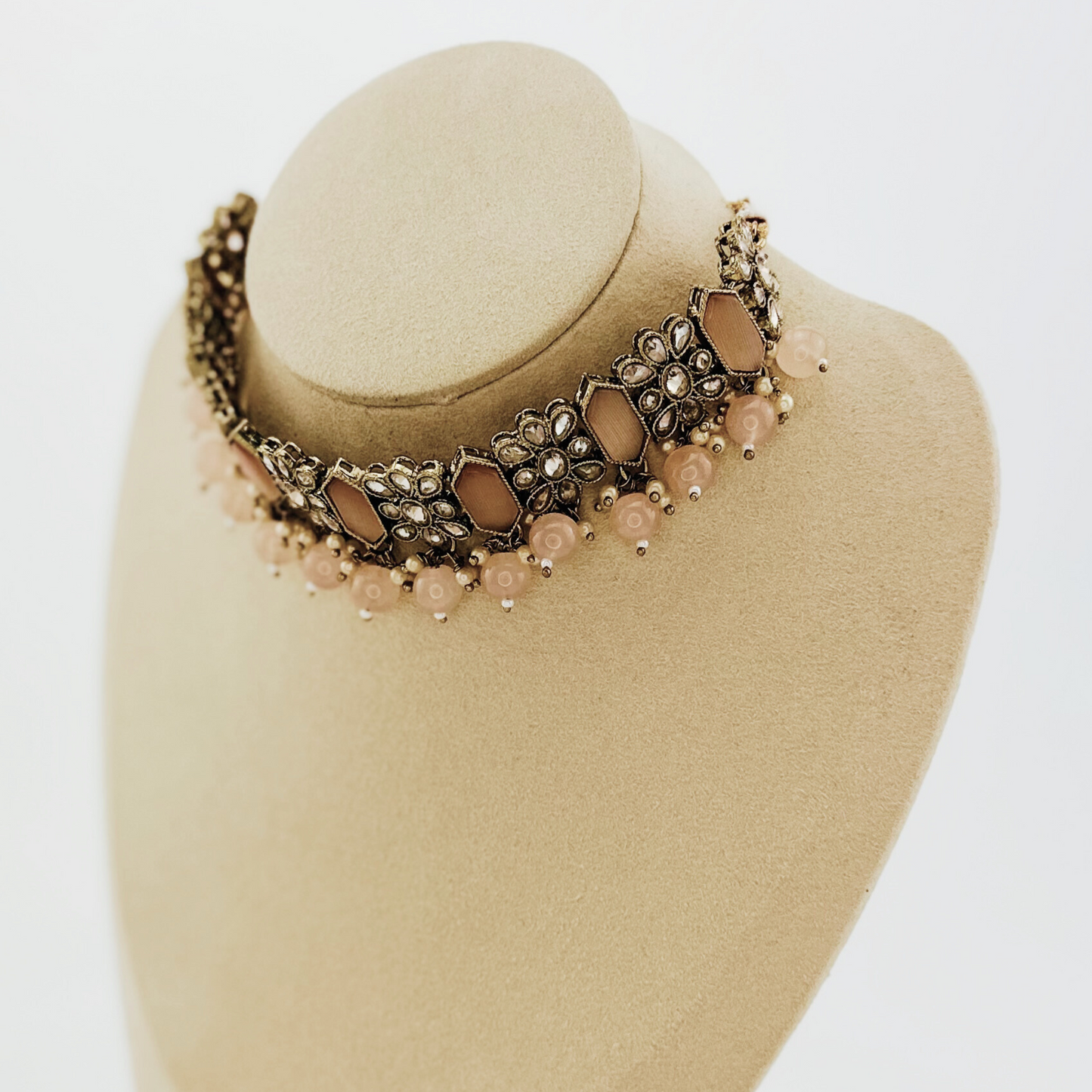 Choker set with baby pink beads and stones. Set includes necklace, tikka & earrings. Prefect for Indian weddings, parties and special occasions. Latest 2023 fashion. High end Indian fashion jewellery with top quality stones and beads.