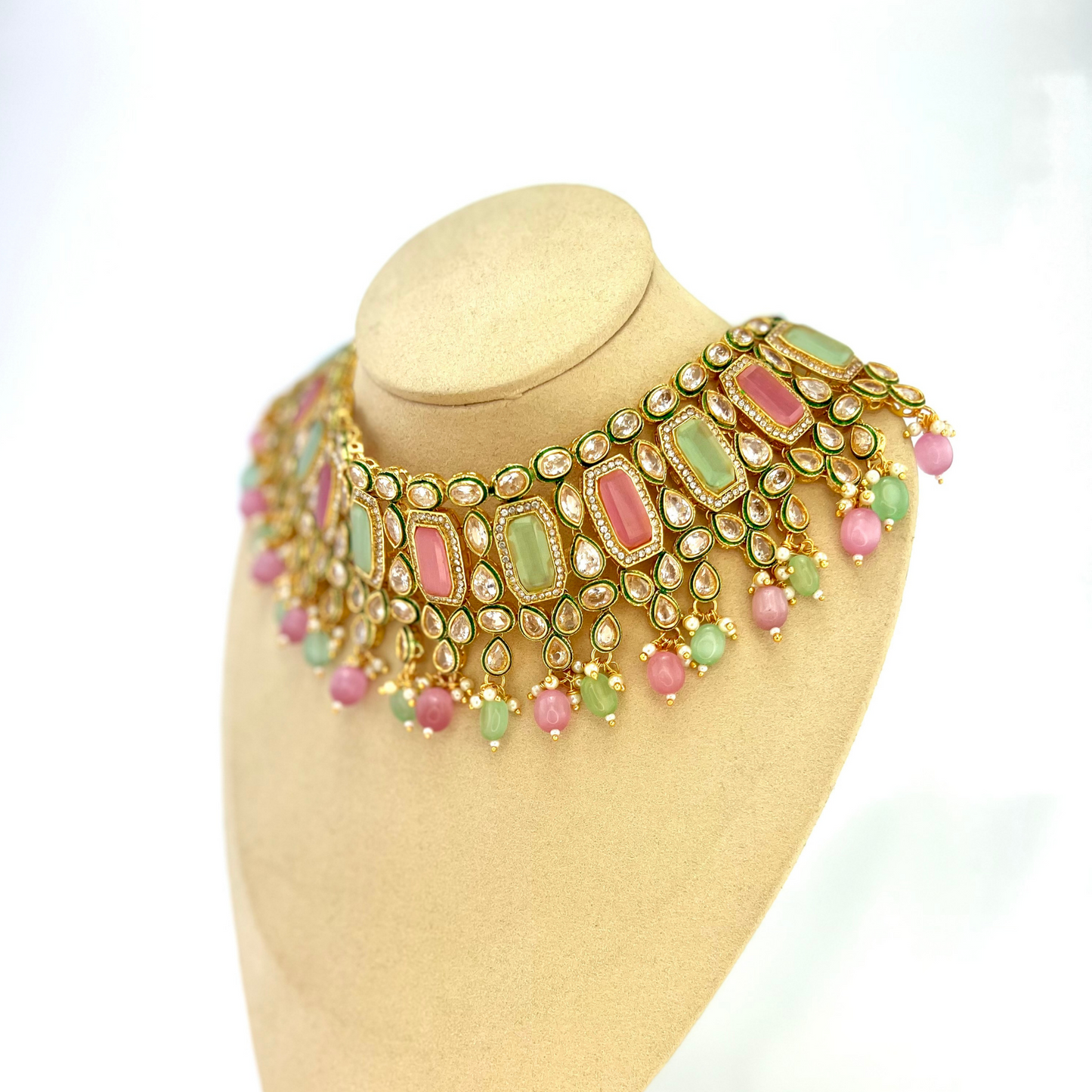 Necklace set with green, pink and clear stones and green and pink beads. Set includes necklace, tikka and earrings. Prefect for Indian weddings, parties and special occasions. Latest 2022 fashion. High end Indian fashion jewellery with top quality stones and beads.