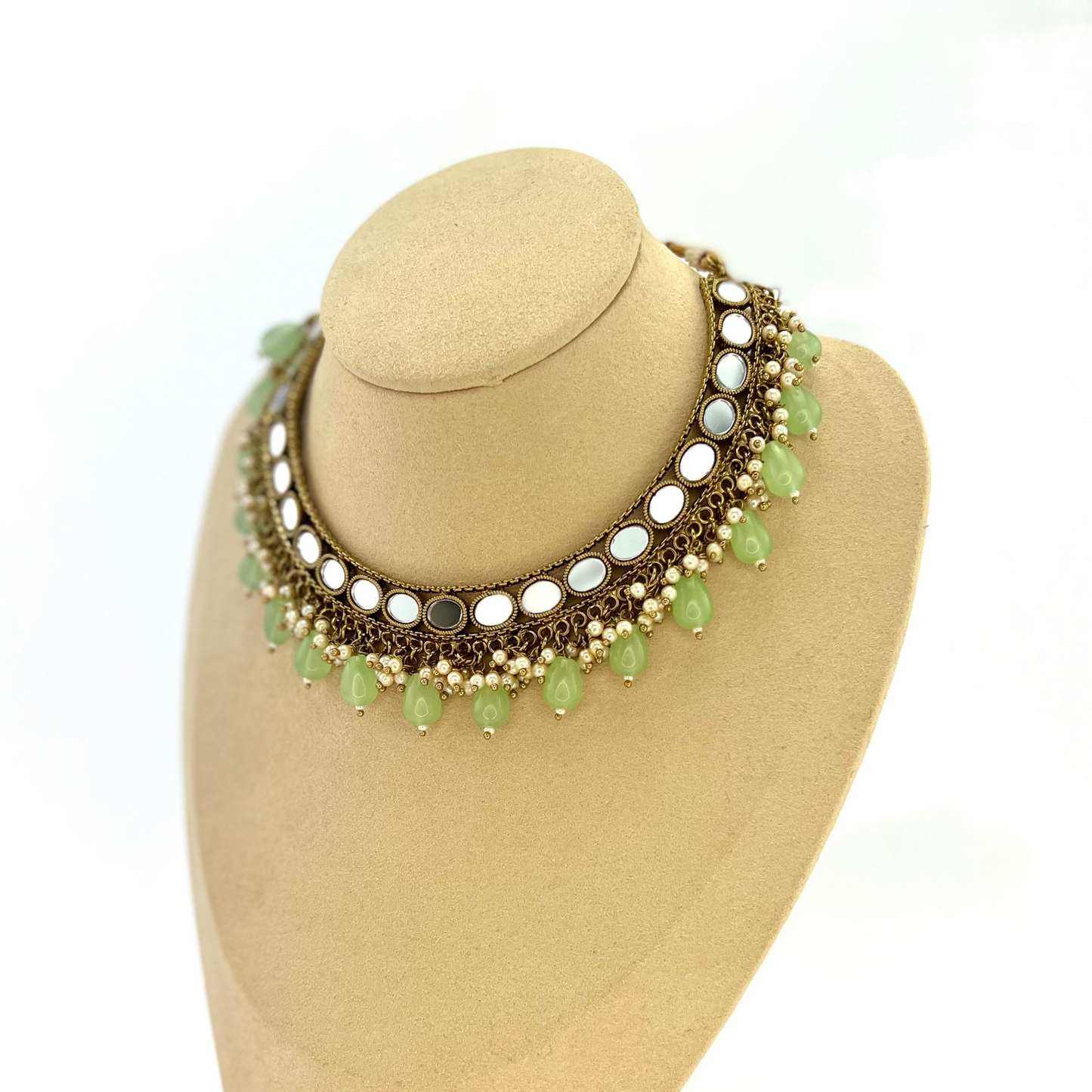Mirror necklace set with green beads and small white pearls. Set includes necklace, tikka and earrings. Prefect for Indian parties, weddings and special occasions. Latest 2022 fashion.