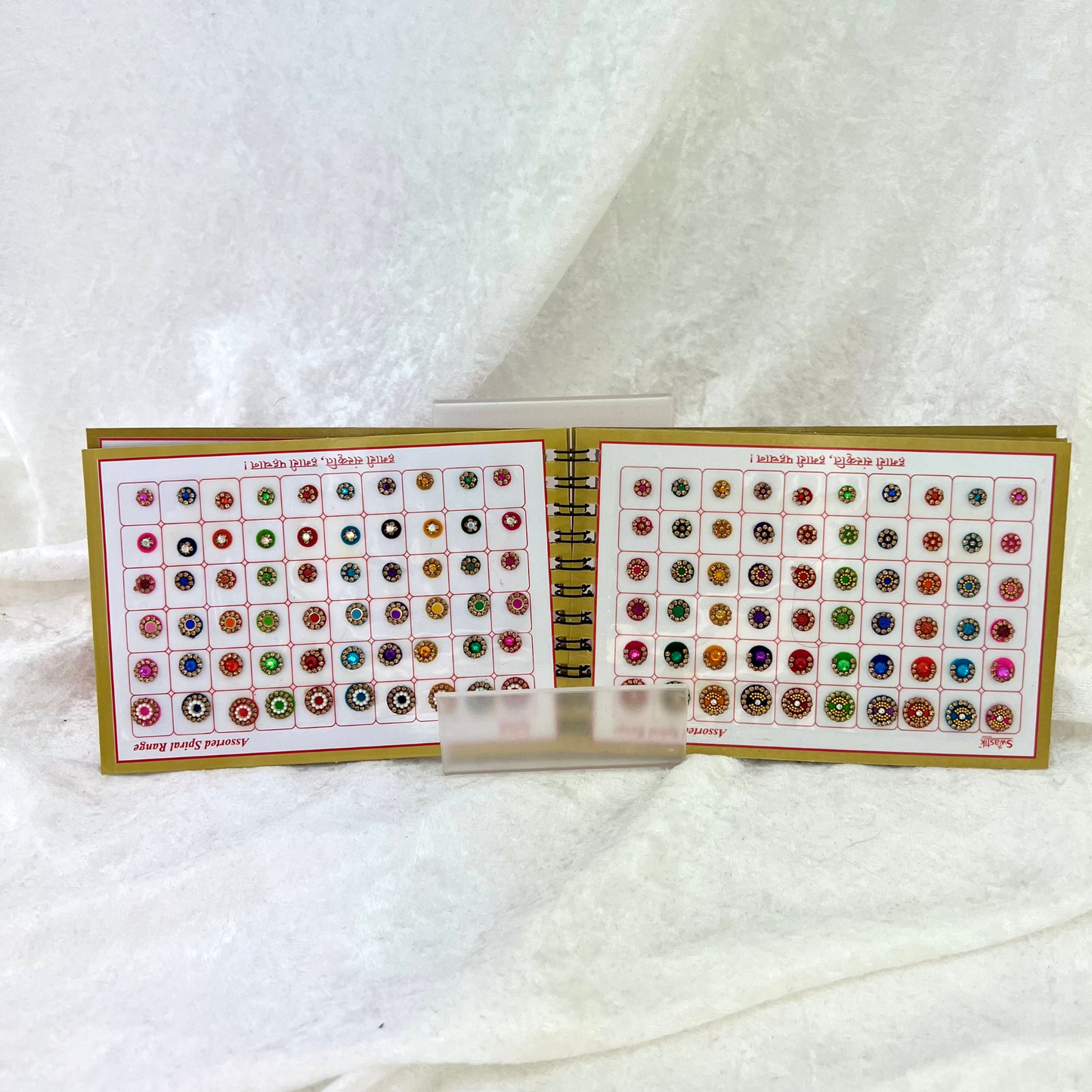 Bindi Book with gold stone work in various different shapes, sizes and colours. Prefect for Indian weddings, parties and special occasions.