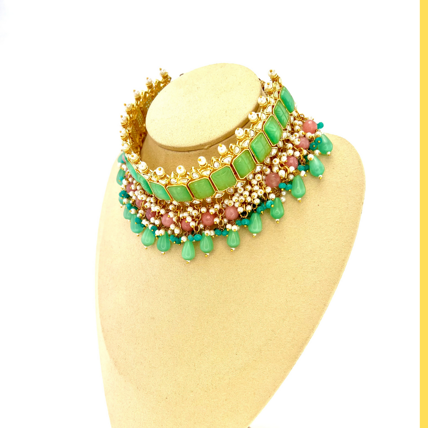 Choker set with with green, clear stones and pink and blue beads. Set includes choker, tikka and earrings. Prefect for Indian weddings, parties and special occasions. Latest 2022 fashion. High end Indian fashion jewellery with top quality stones and beads.