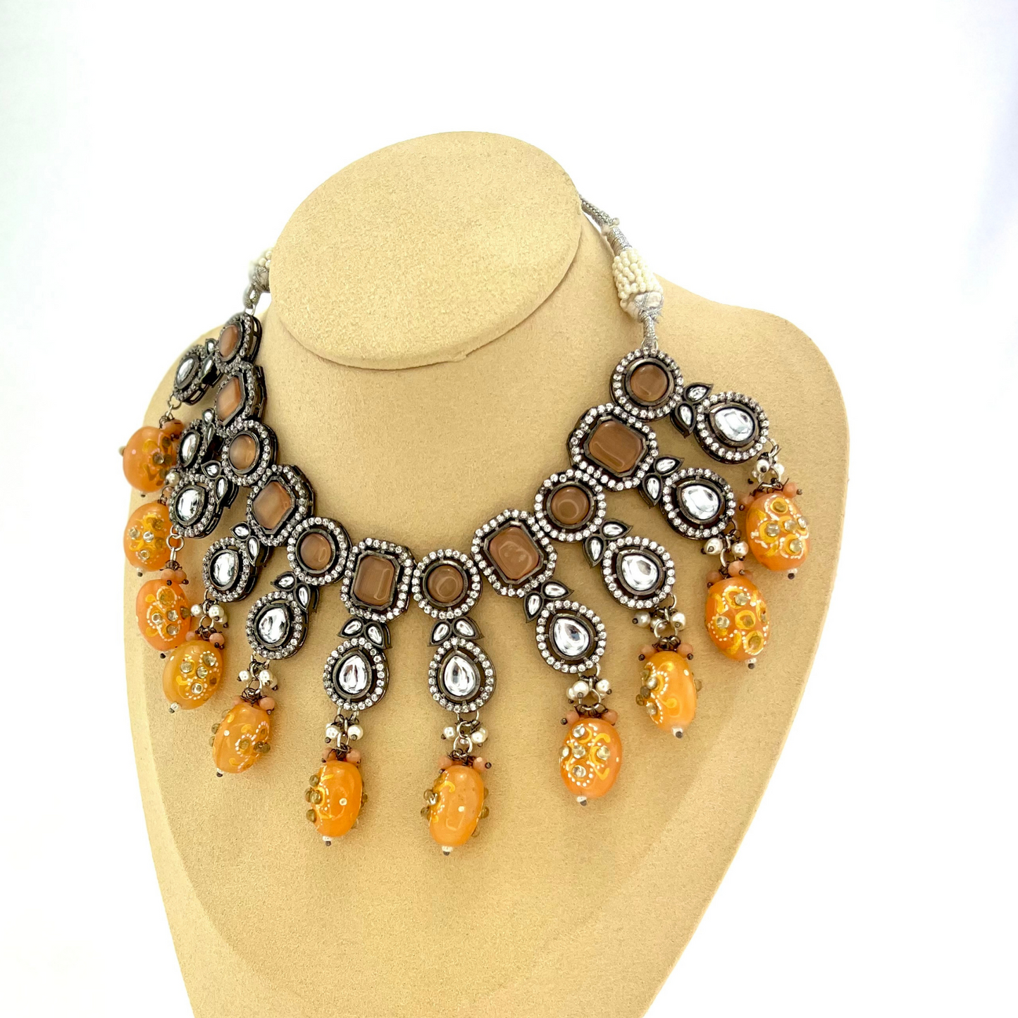 Kundan necklace set with peach and clear stone work. Set includes necklace and earrings. Prefect for Indian weddings, parties and special occasions. Latest 2022 fashion. High end Indian fashion jewellery with top quality stones and beads.