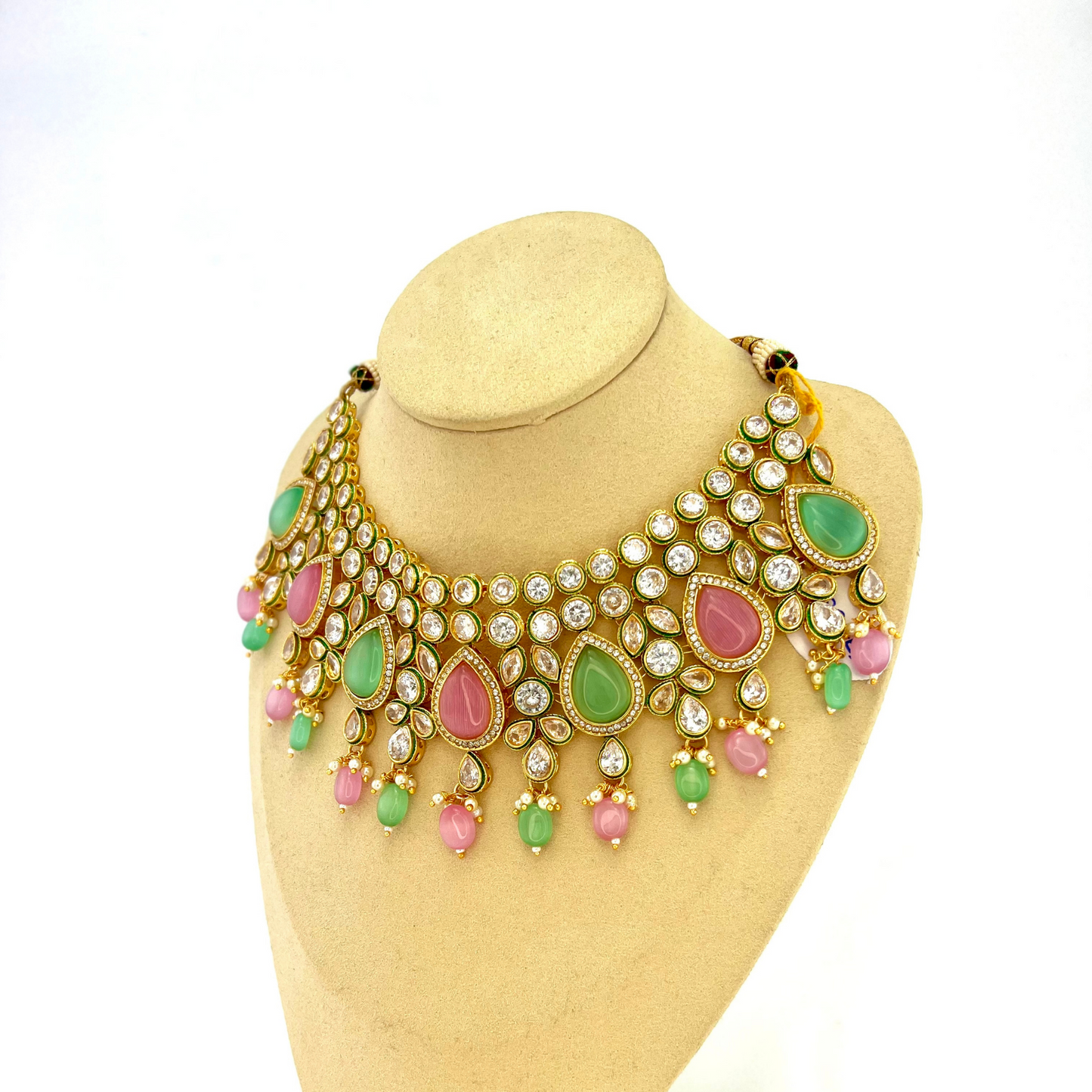Necklace set with green, pink and clear stones and green and pink beads. Set includes necklace, tikka and earrings. Prefect for Indian weddings, parties and special occasions. Latest 2022 fashion. High end Indian fashion jewellery with top quality stones and beads.