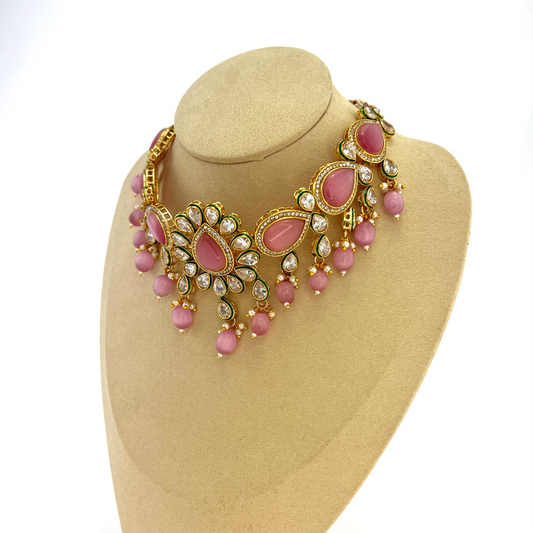 Choker set with pink, clear stones and pink beads. Set includes choker, tikka and earrings. Prefect for Indian weddings, parties and special occasions. Latest 2022 fashion. High end Indian fashion jewellery with top quality stones and beads.