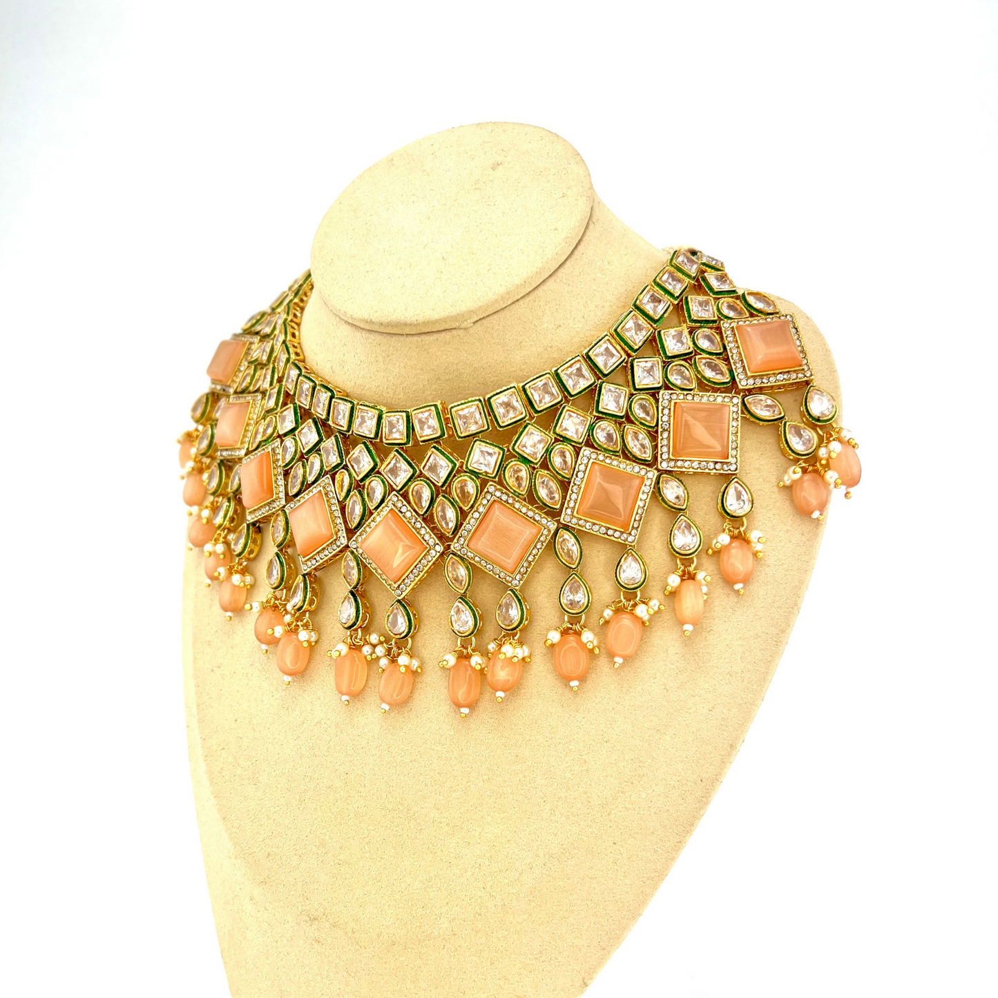 Necklace set with peach beads and peach and clear stone. Set includes necklace, tikka & earrings. Prefect for Indian weddings, parties and special occasions. Latest 2022 fashion. High end Indian fashion jewellery with top quality stones and beads.
