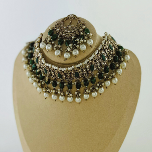 Necklace set with green stones and white pearl beads. Set includes necklace, tikka & earrings. Prefect for Indian weddings, parties and special occasions. Latest 2023 fashion. High end Indian fashion jewellery with top quality stones and beads.