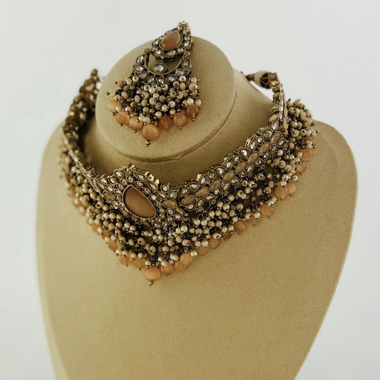 Choker set with peach beads and stones. Set includes necklace, tikka & earrings. Prefect for Indian weddings, parties and special occasions. Latest 2023 fashion. High end Indian fashion jewellery with top quality stones and beads.