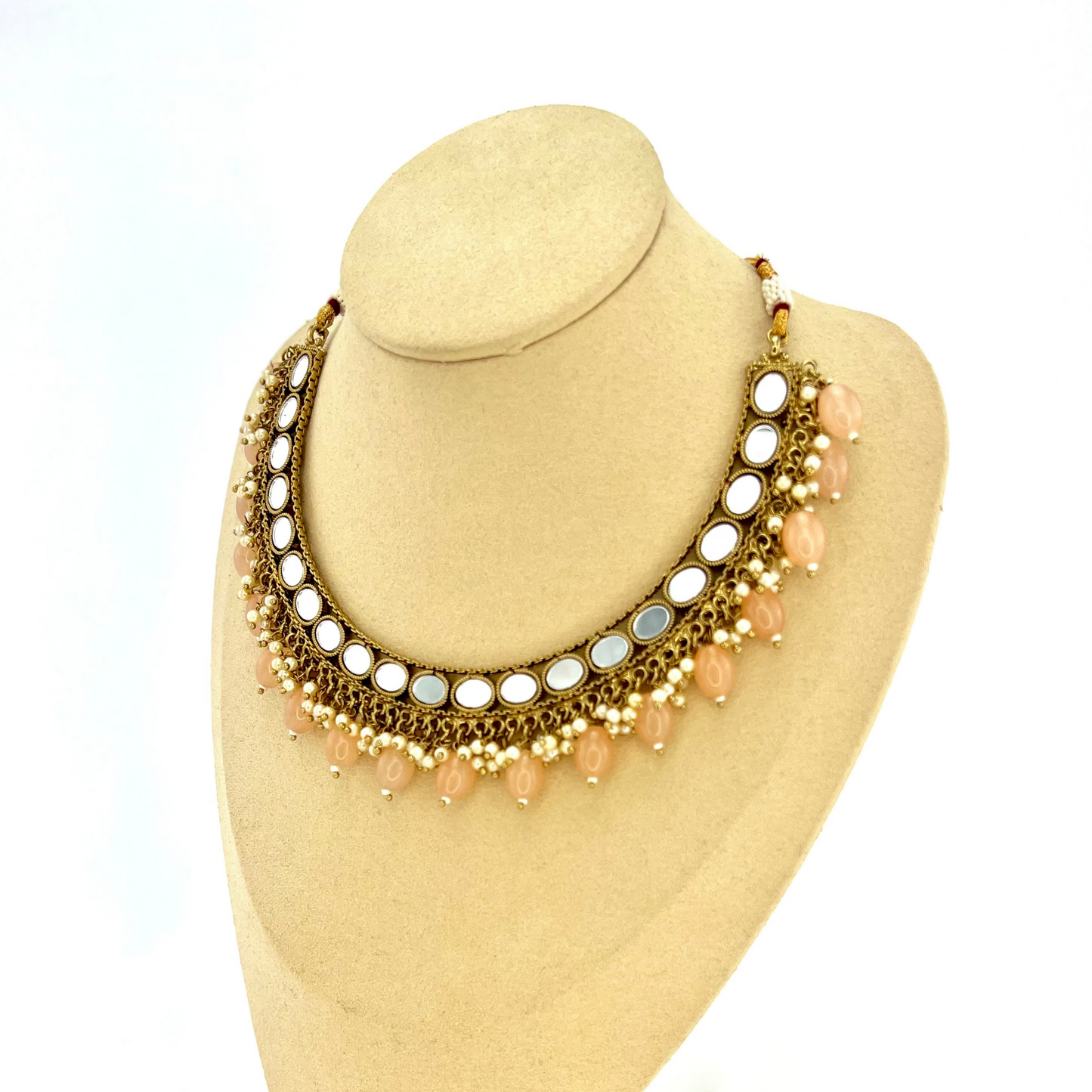 Mirror necklace set with peach beads and small white pearls. Set includes necklace, tikka and earrings. Prefect for Indian parties, weddings and special occasions. Latest 2022 fashion.