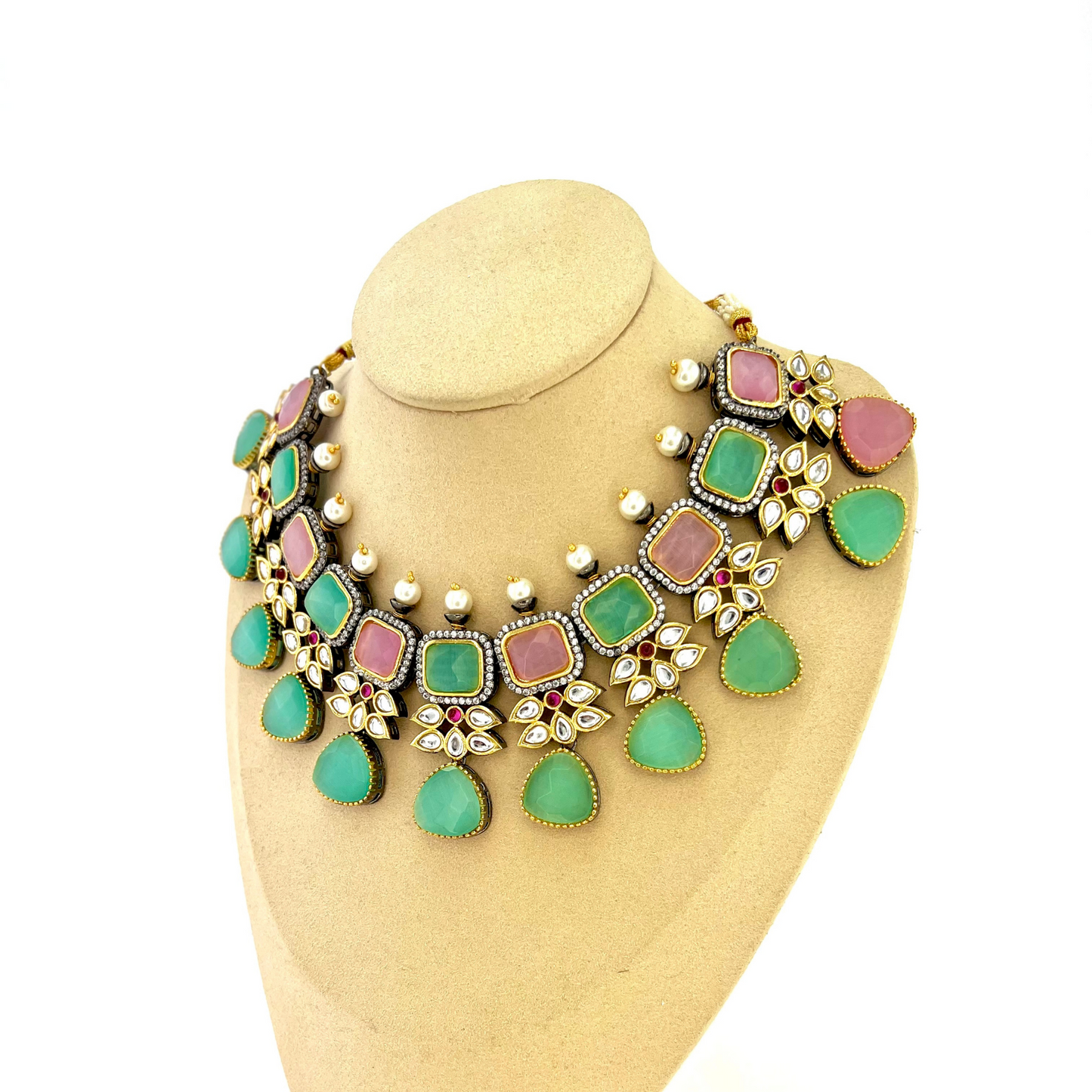 Necklace set with green, pink and silver stone work finished with small white pearls. Set includes necklace, tikka and earrings. Prefect for Indian parties, weddings and special occasions. Latest 2022 fashion