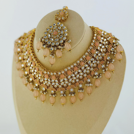 Necklace set with peach stones and beads. Set includes necklace, tikka & earrings. Prefect for Indian weddings, parties and special occasions. Latest 2023 fashion. High end Indian fashion jewellery with top quality stones and beads.
