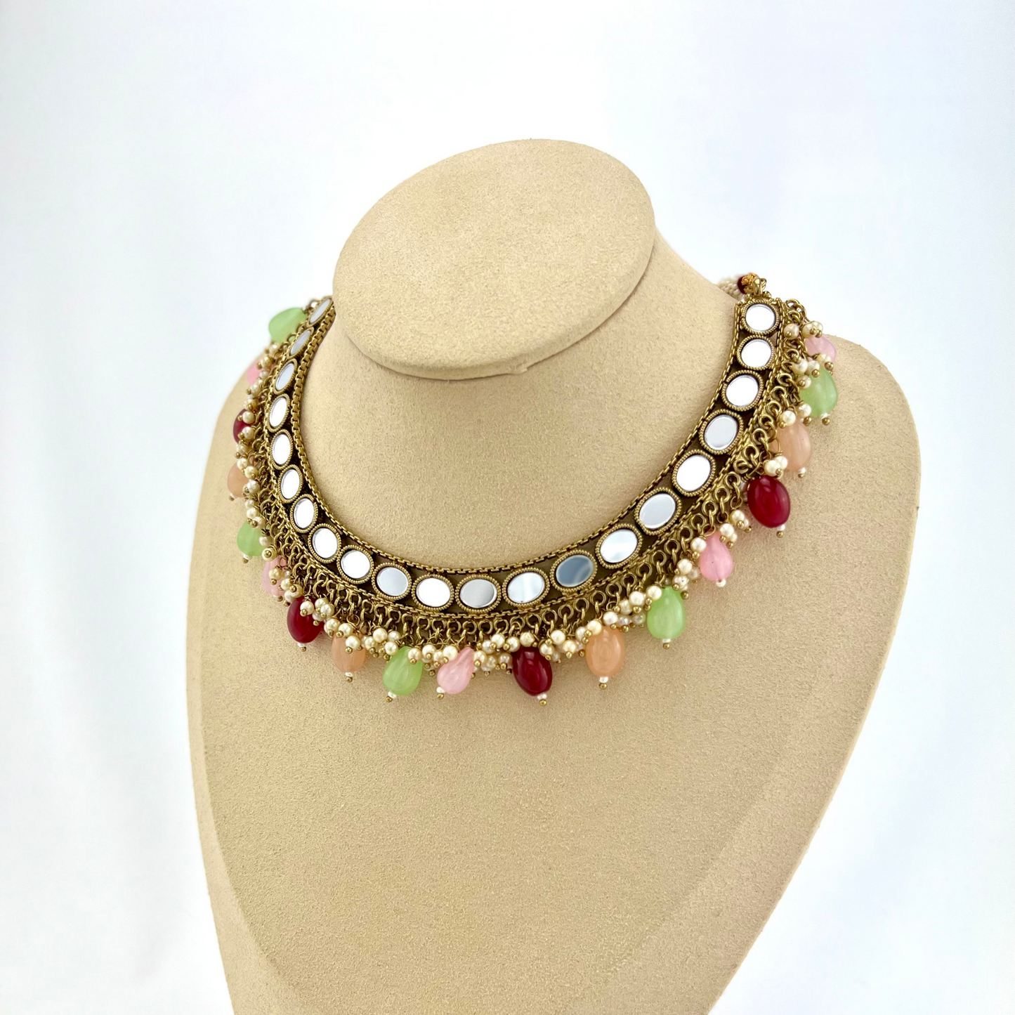 Mirror necklace set with multi colour beads and small white pearls. Set includes necklace, tikka and earrings. Prefect for Indian parties, weddings and special occasions. Latest 2022 fashion.