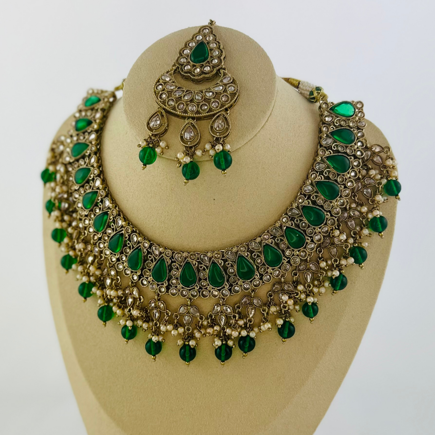 Necklace set with green beads and stone. Set includes necklace, tikka & earrings. Prefect for Indian weddings, parties and special occasions. Latest 2023 fashion. High end Indian fashion jewellery with top quality stones and beads.